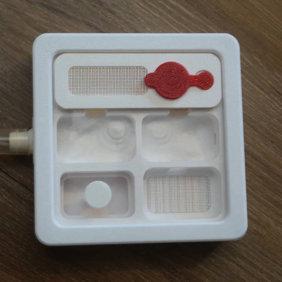 Show: The Hybrid Nest Air from above with the red top off, showing its four chambers